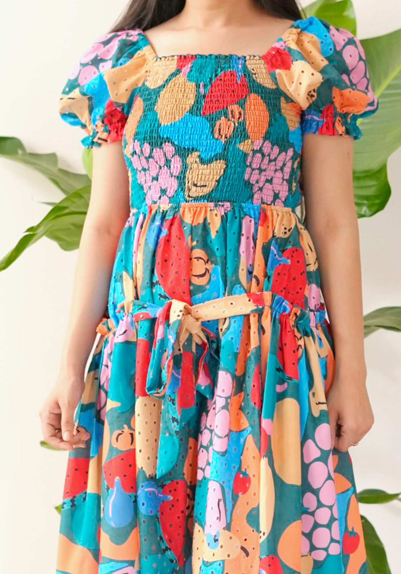 Colorful dress with floral and abstract patterns on a blurred background