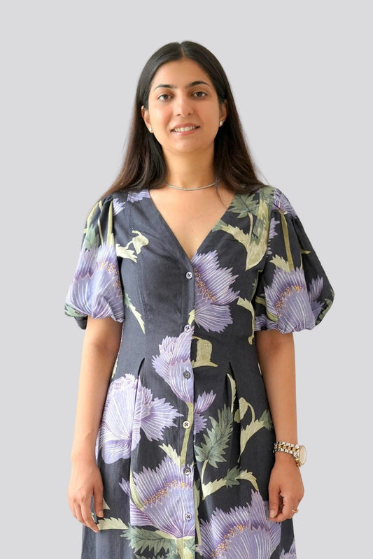 Woman wearing a floral dress with a plain background