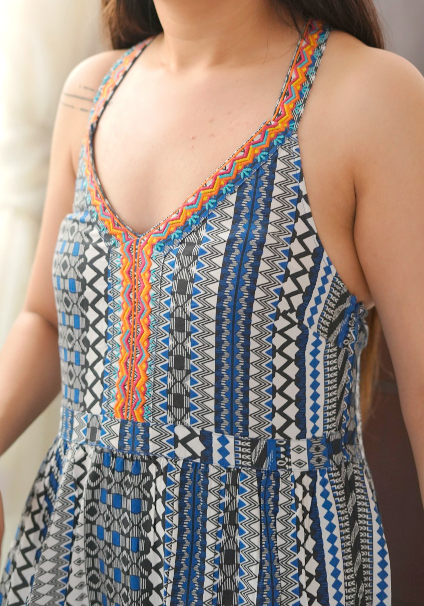 Close-up of a patterned dress with a deep neckline.