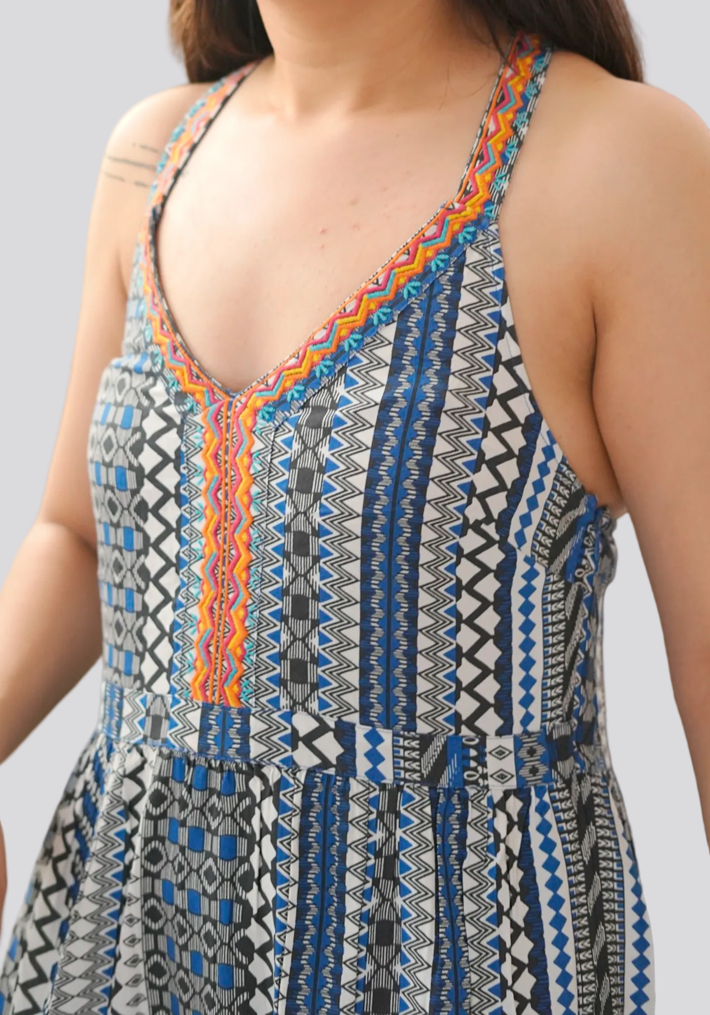 Close-up of a patterned dress with a deep neckline.