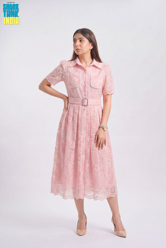 Woman wearing a pink dress with a belt on a white background