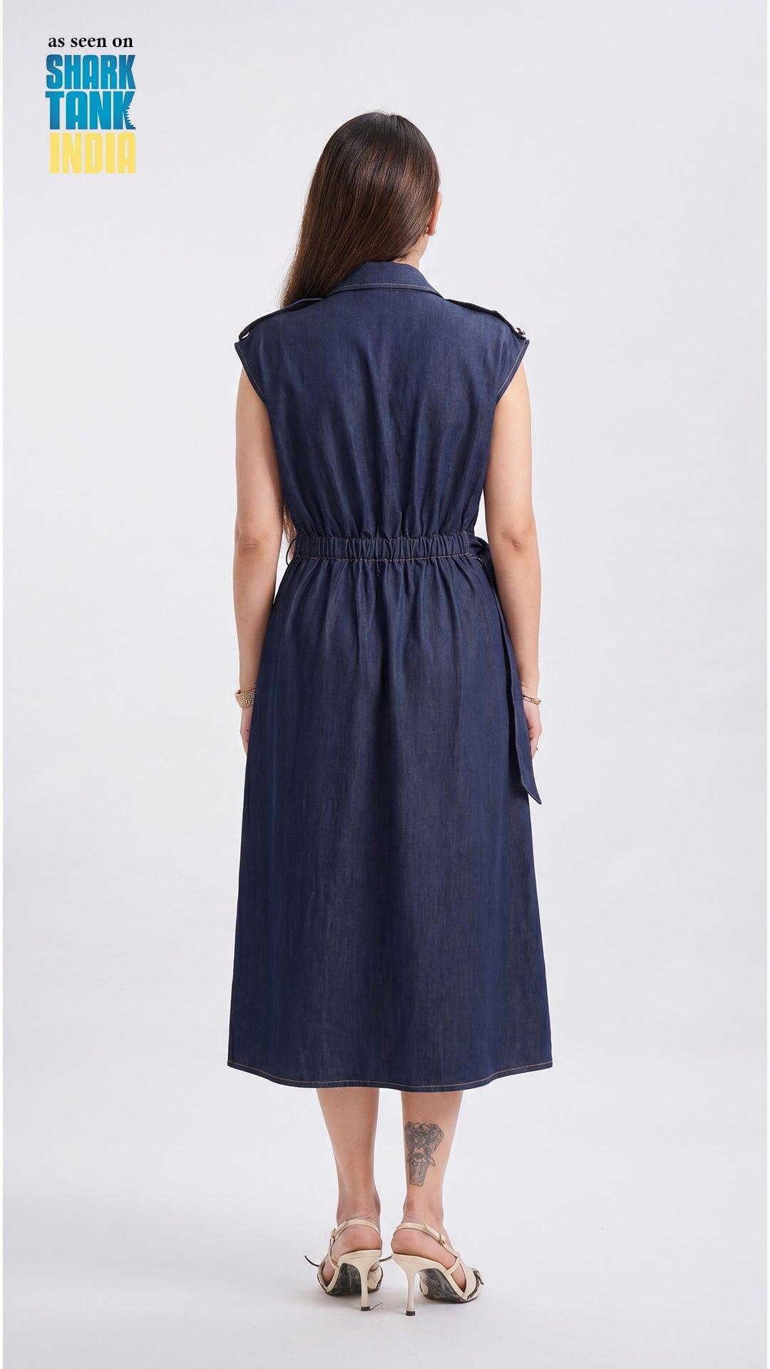 Woman wearing a navy blue dress on a white background with 'Shark Tank' branding.