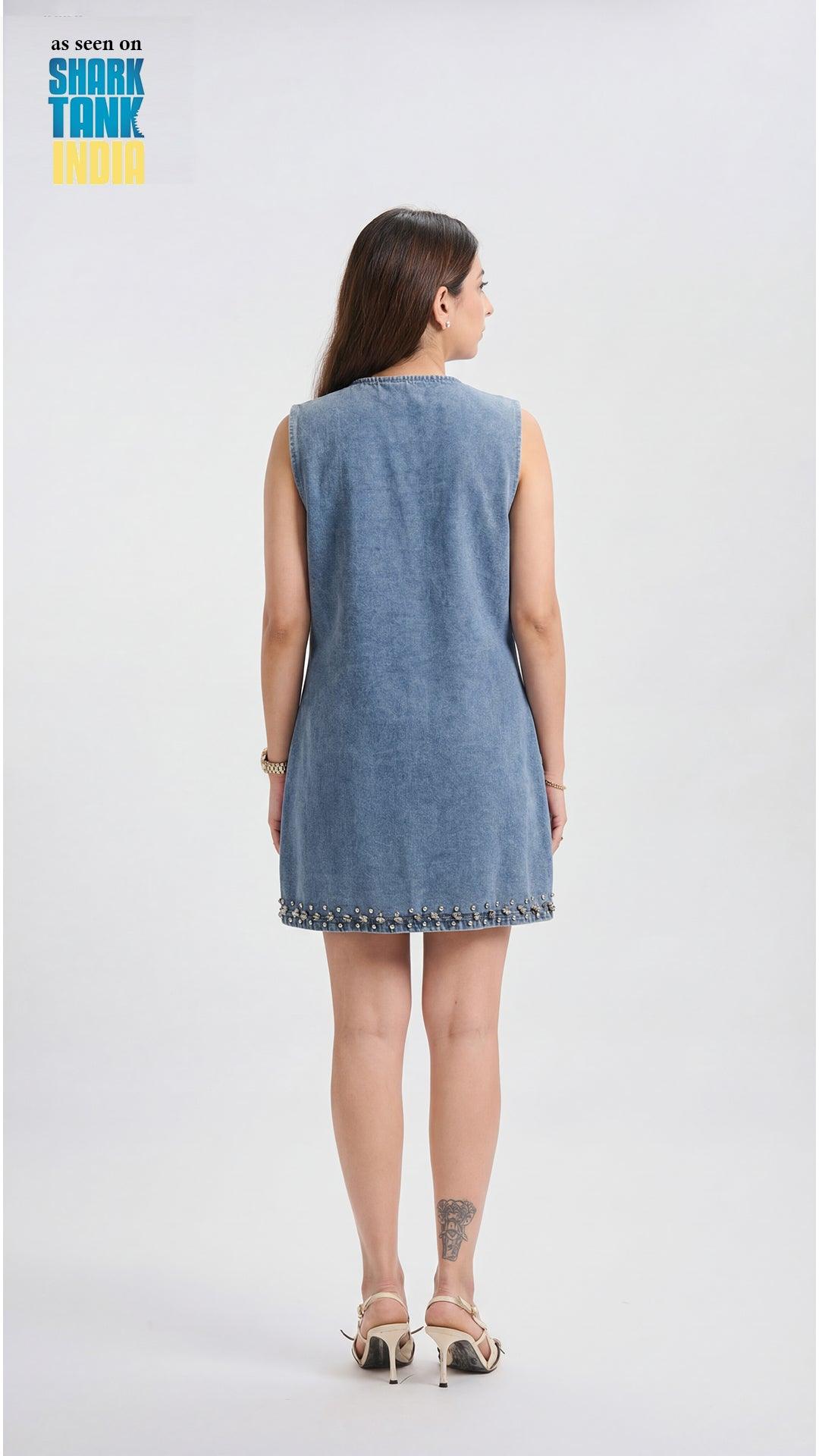 Woman wearing a denim dress with a plain background