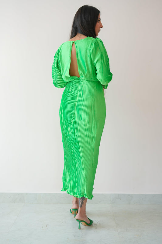 Green dress with cut-out design worn by a person against a white background