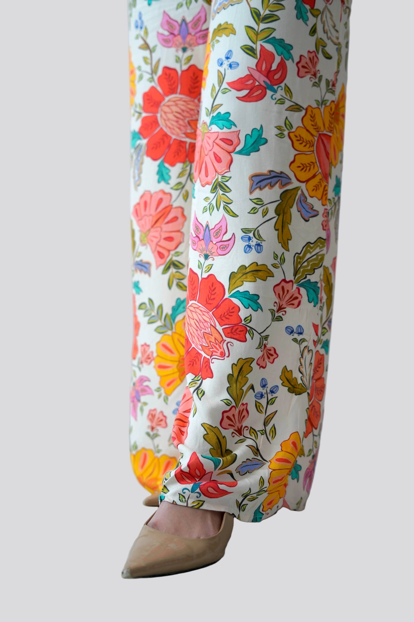 Colorful floral pants on a plain background