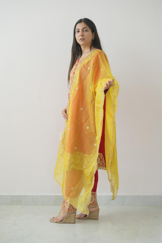 Woman wearing a yellow traditional outfit with a white background