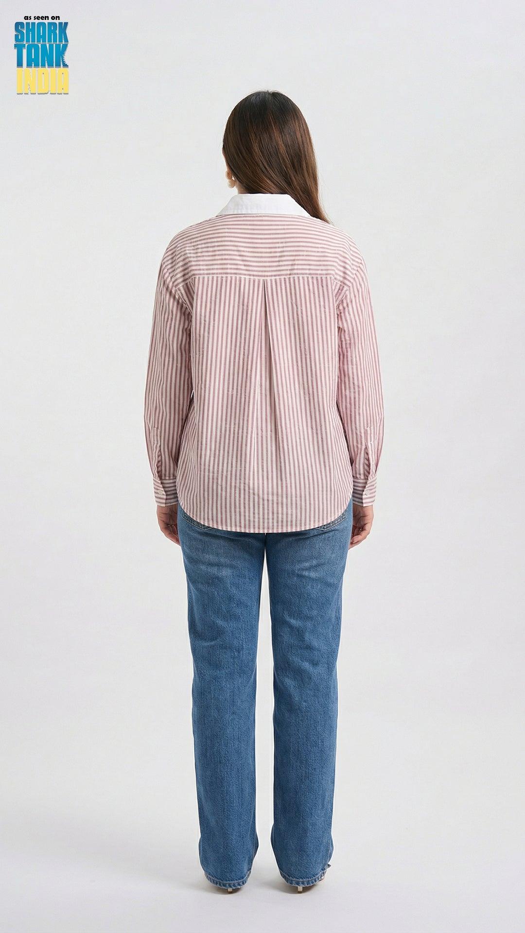 Woman wearing a striped shirt and jeans on a white background