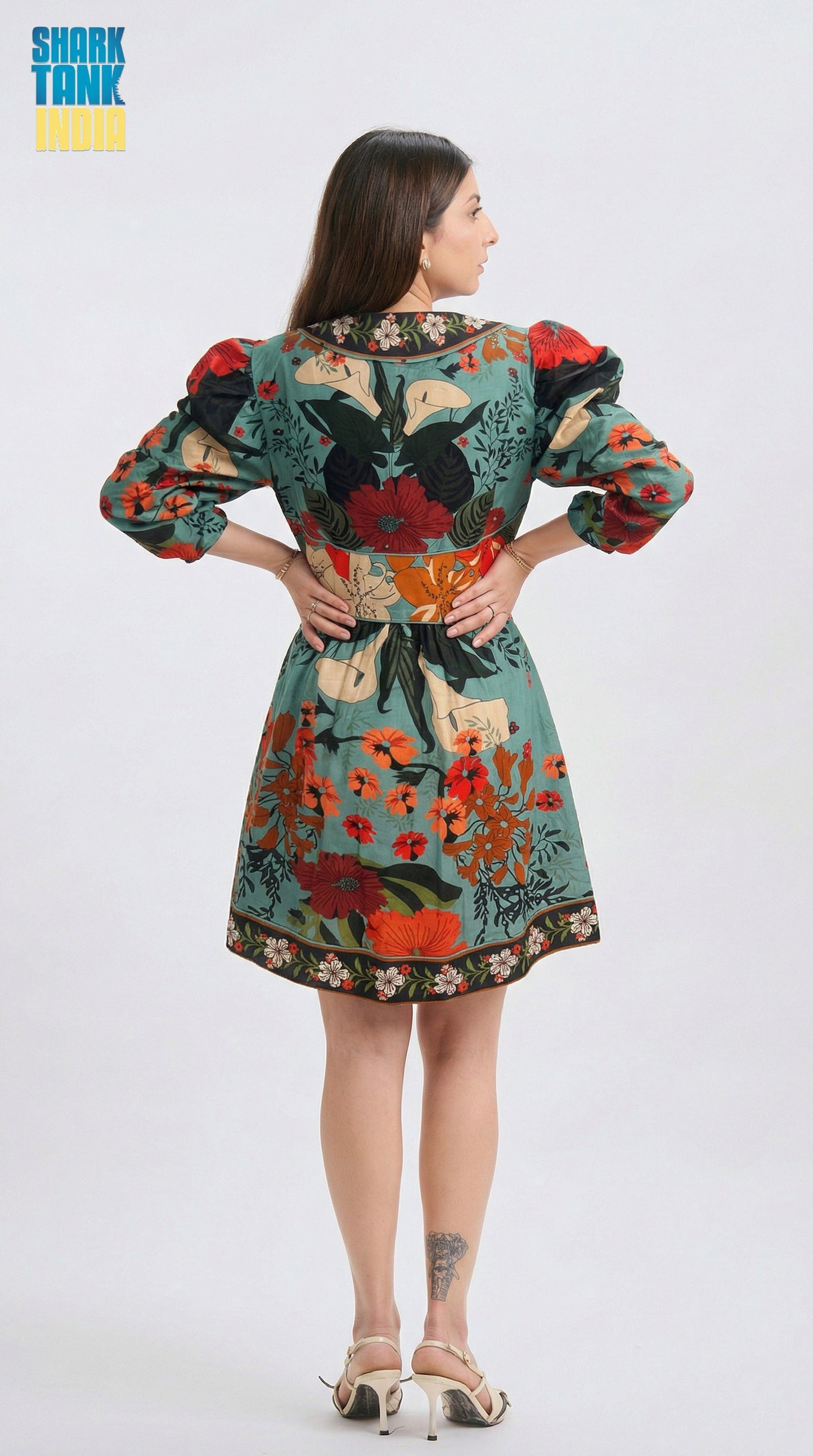 Woman wearing a colorful floral dress on a white background
