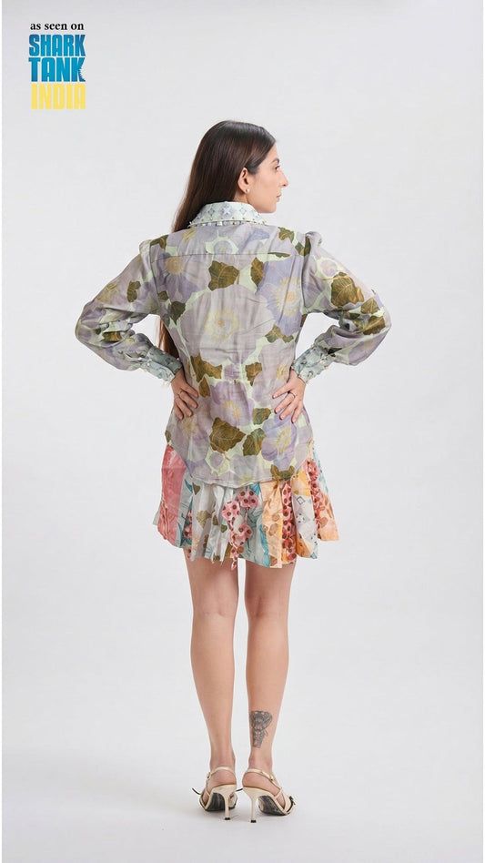 Woman wearing a colorful floral dress with a white background