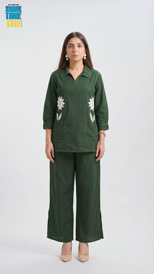 Woman wearing a green outfit with floral patterns on a white background