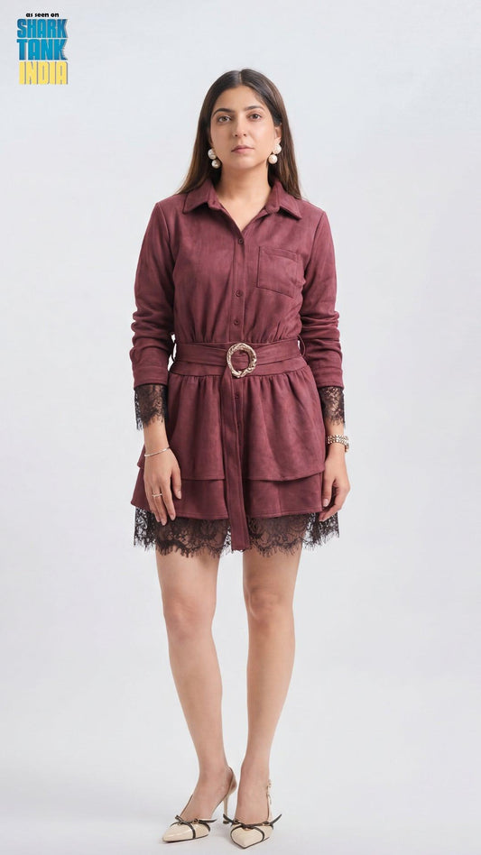 Woman wearing a burgundy dress with lace details on a white background