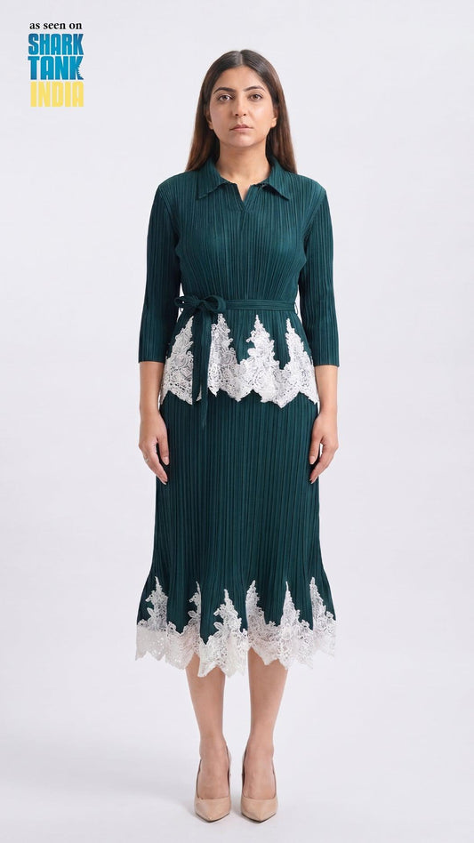 Woman wearing a green dress with white lace details on a white background