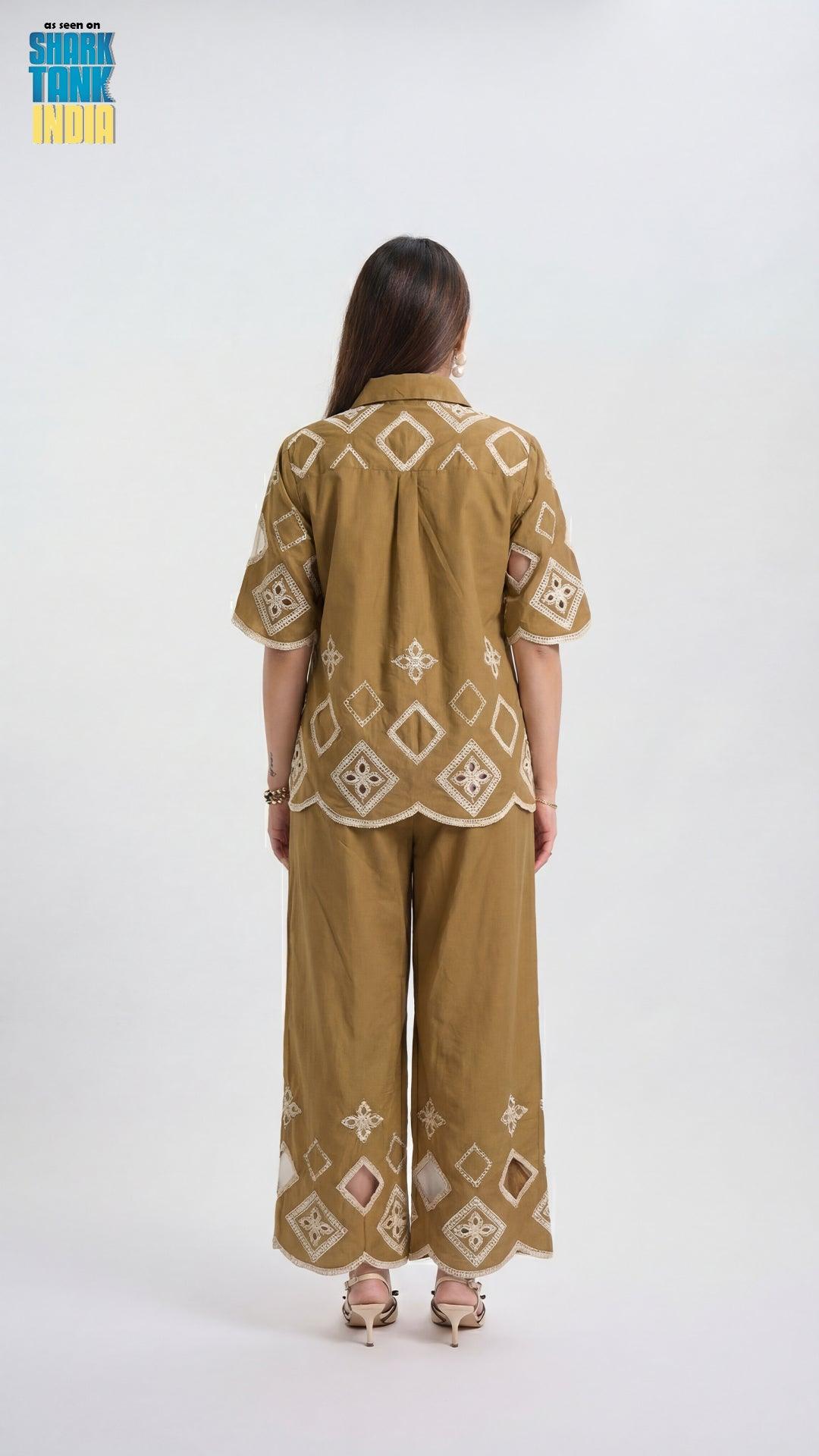 Woman wearing a patterned outfit on a white background