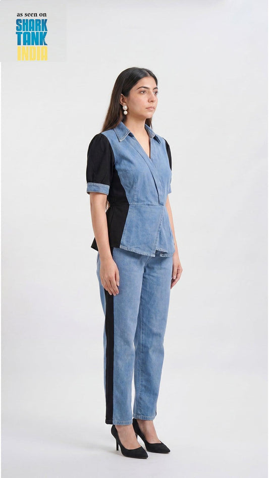 Woman wearing a denim outfit with a black top on a white background
