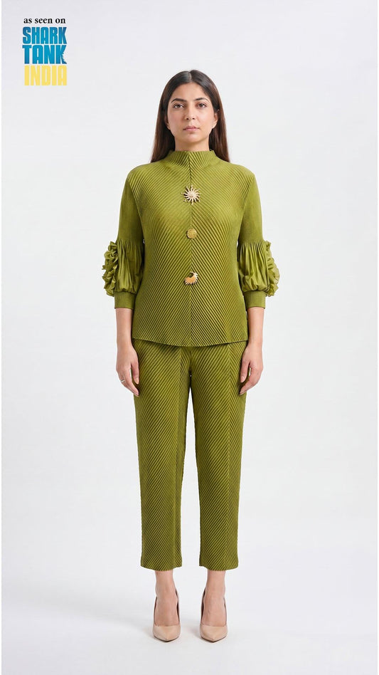 Woman wearing a green outfit with a brooch on a white background