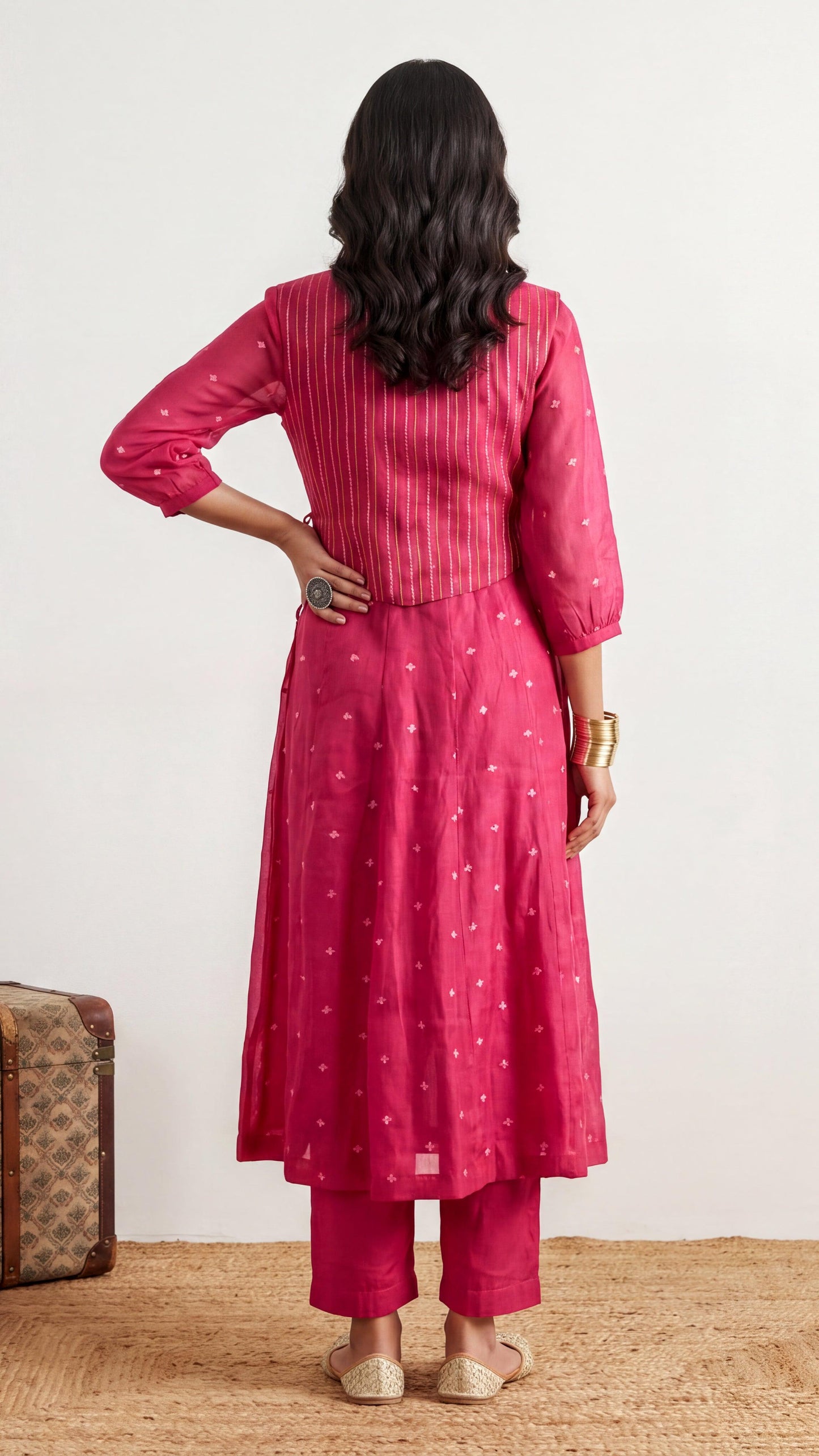 Woman wearing a pink traditional outfit with a white background