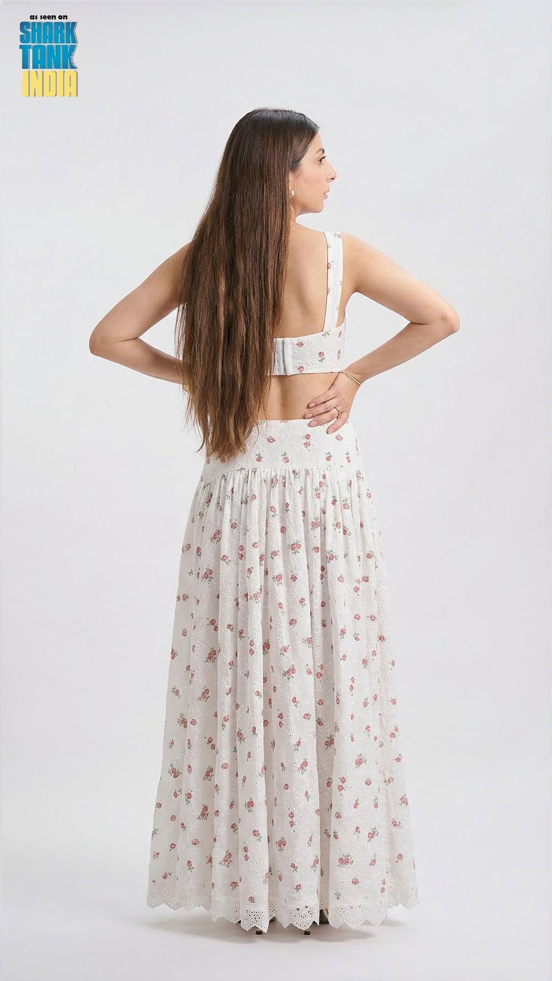 Woman wearing a white floral dress on a white background