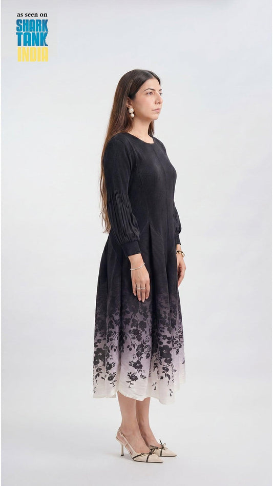 Woman wearing a black dress with floral pattern on a white background