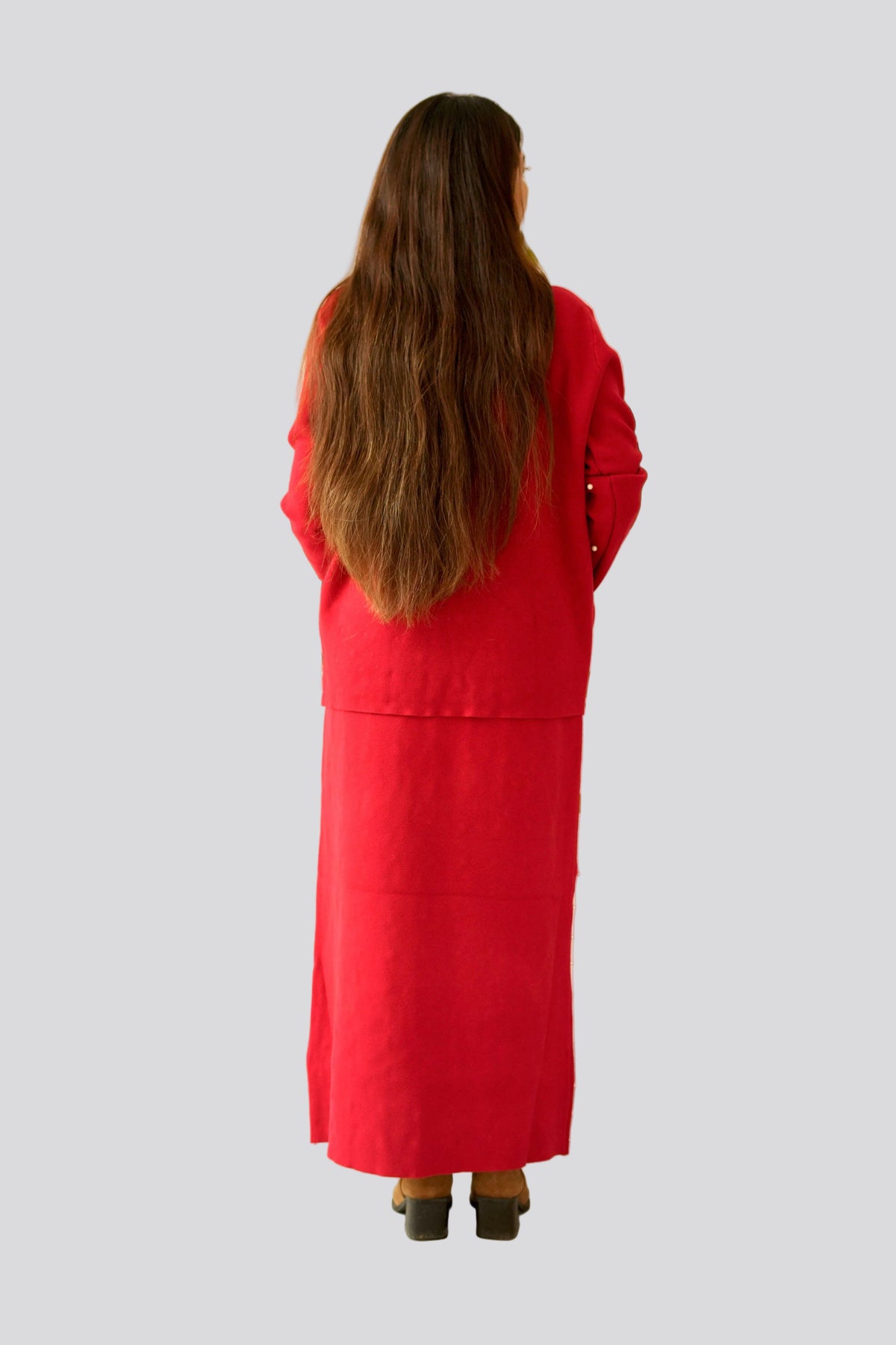 Person wearing a long red coat from behind on a white background