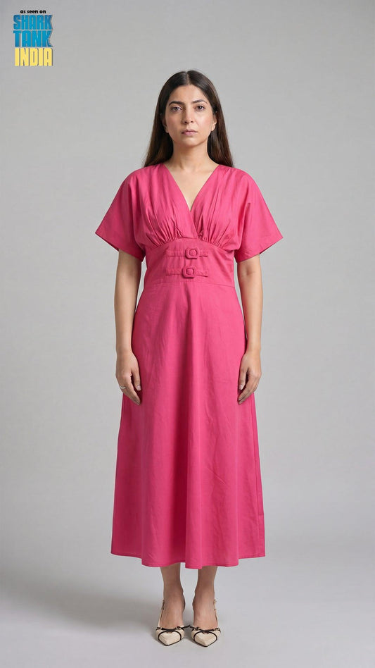 Woman wearing a pink dress against a gray background