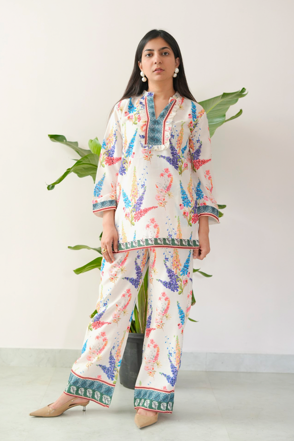 Woman wearing a colorful pajama set with a white background