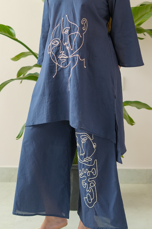 Navy blue outfit with white line art designs on a neutral background