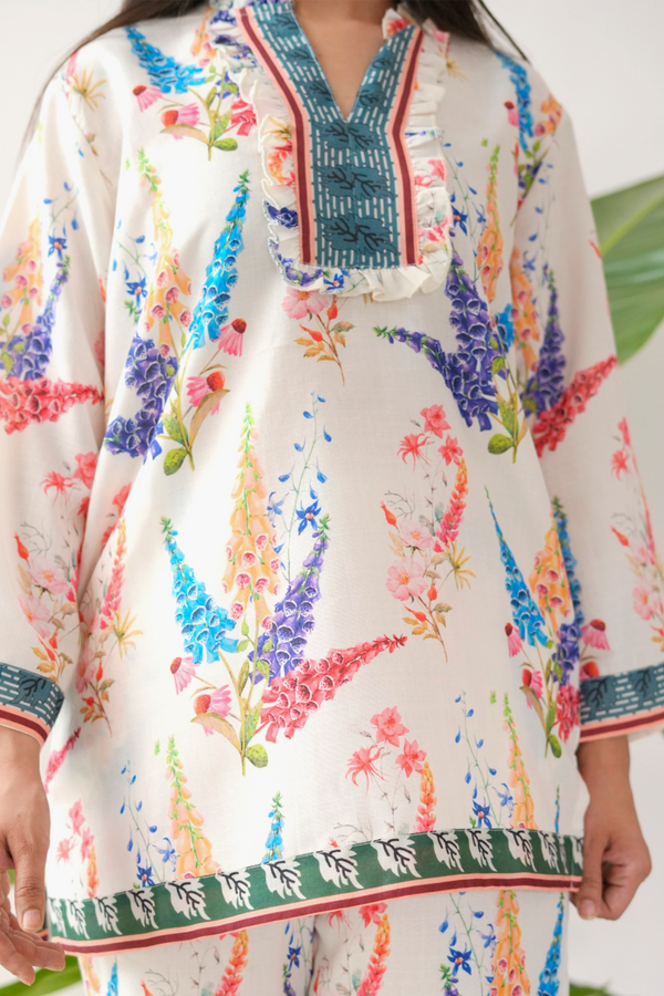 Colorful floral dress with intricate details on a white background