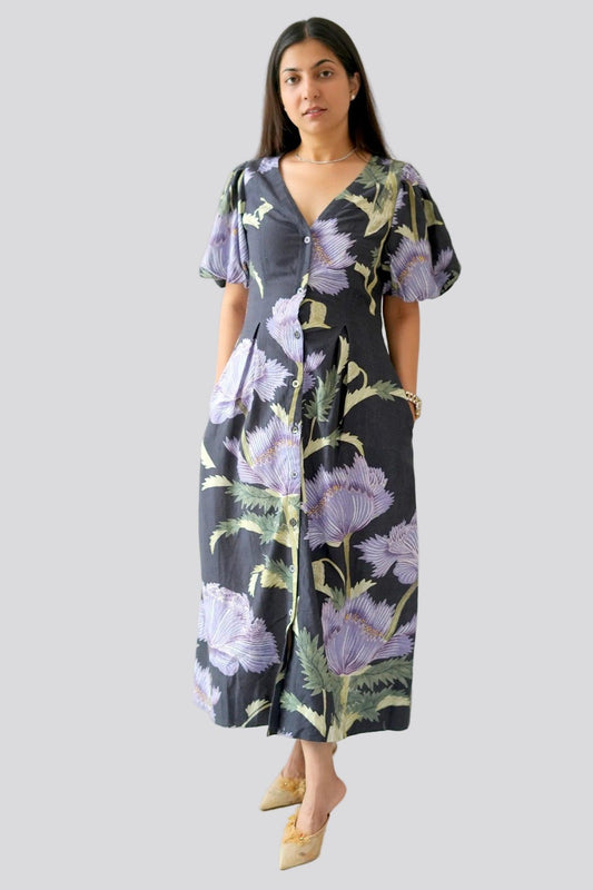 Woman wearing a floral dress on a plain background