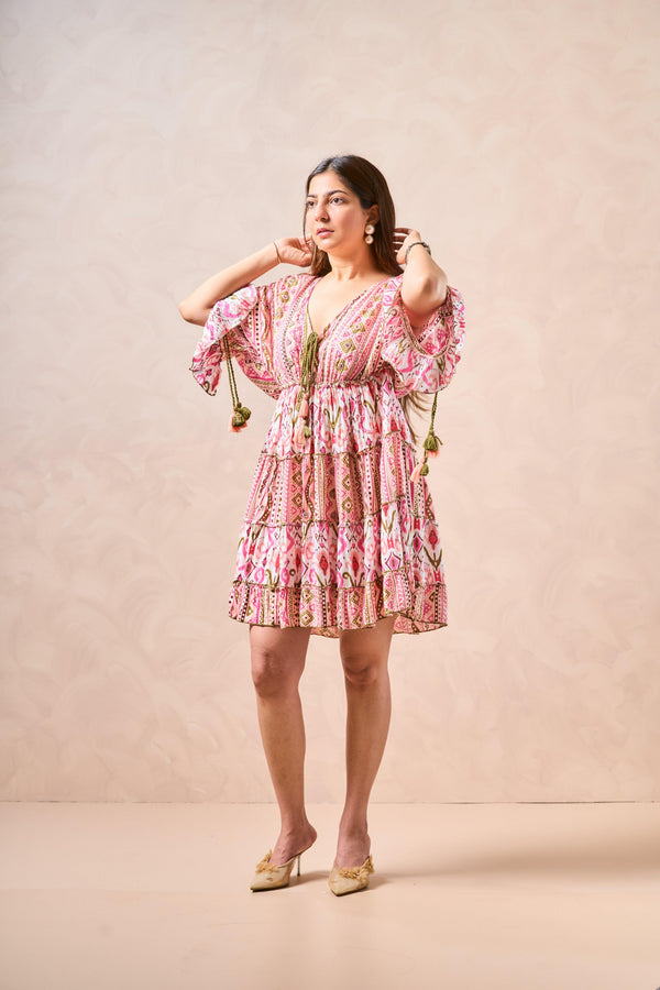 Woman wearing a pink floral dress against a beige background