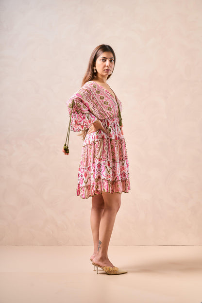 Woman wearing a pink floral dress against a beige background