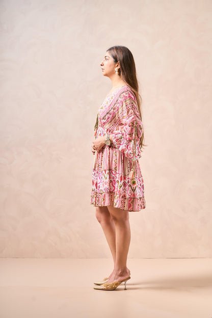 Woman wearing a pink floral dress against a beige background