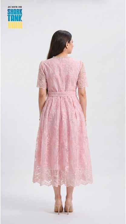 Woman wearing a pink lace dress on a white background with 'Shark Tank' branding.