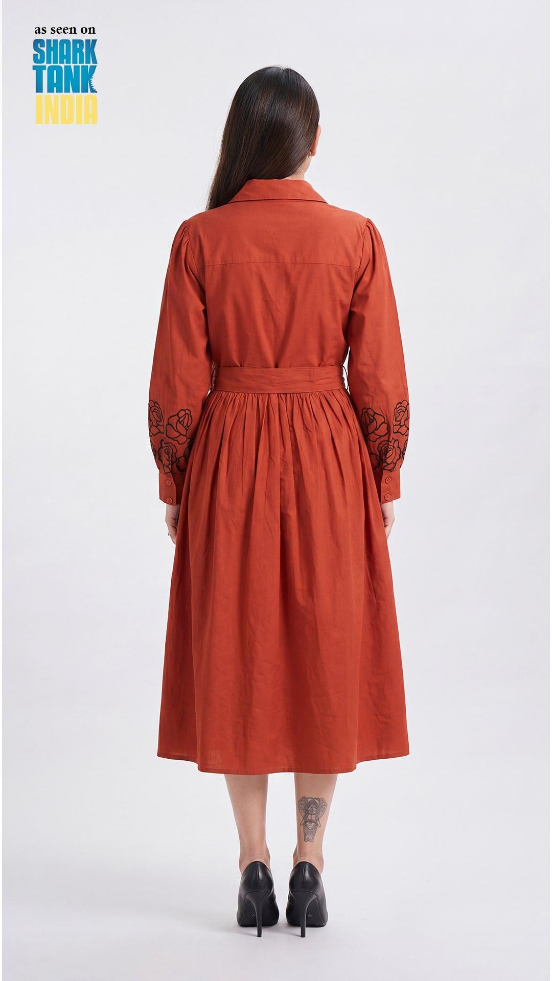 Woman wearing an orange dress with lace sleeves on a white background