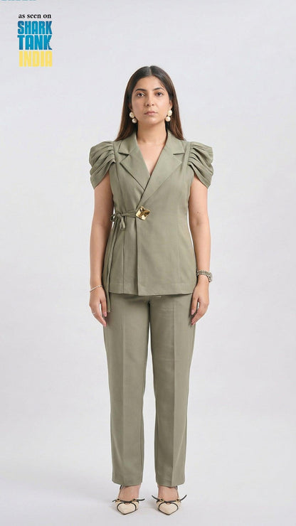 Woman wearing a green suit with a white background