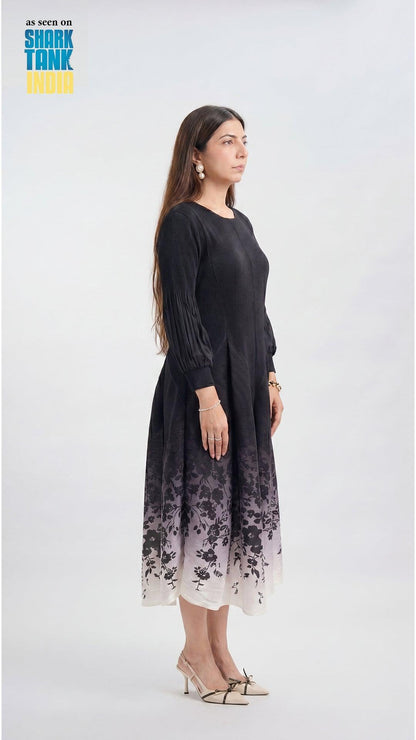 Woman wearing a black dress with floral pattern on a white background