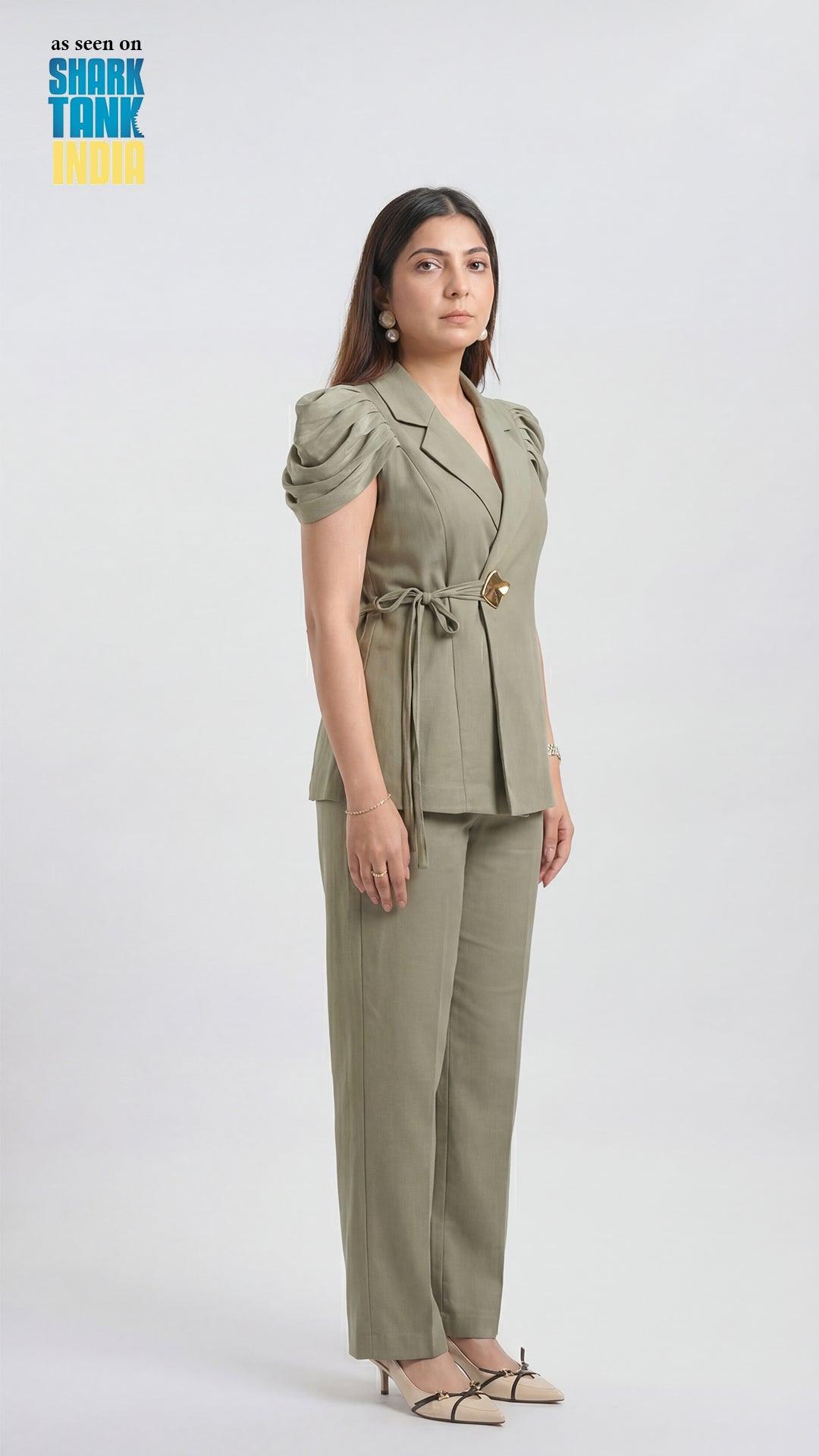 Woman wearing a green outfit on a white background with 'Shark Tank' branding.