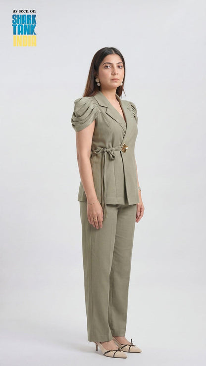 Woman wearing a green outfit on a white background with 'Shark Tank' branding.