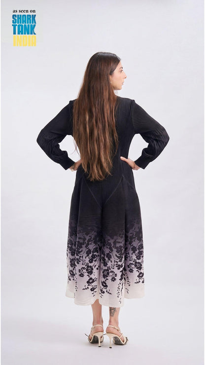 Woman wearing a black dress with floral pattern on a white background