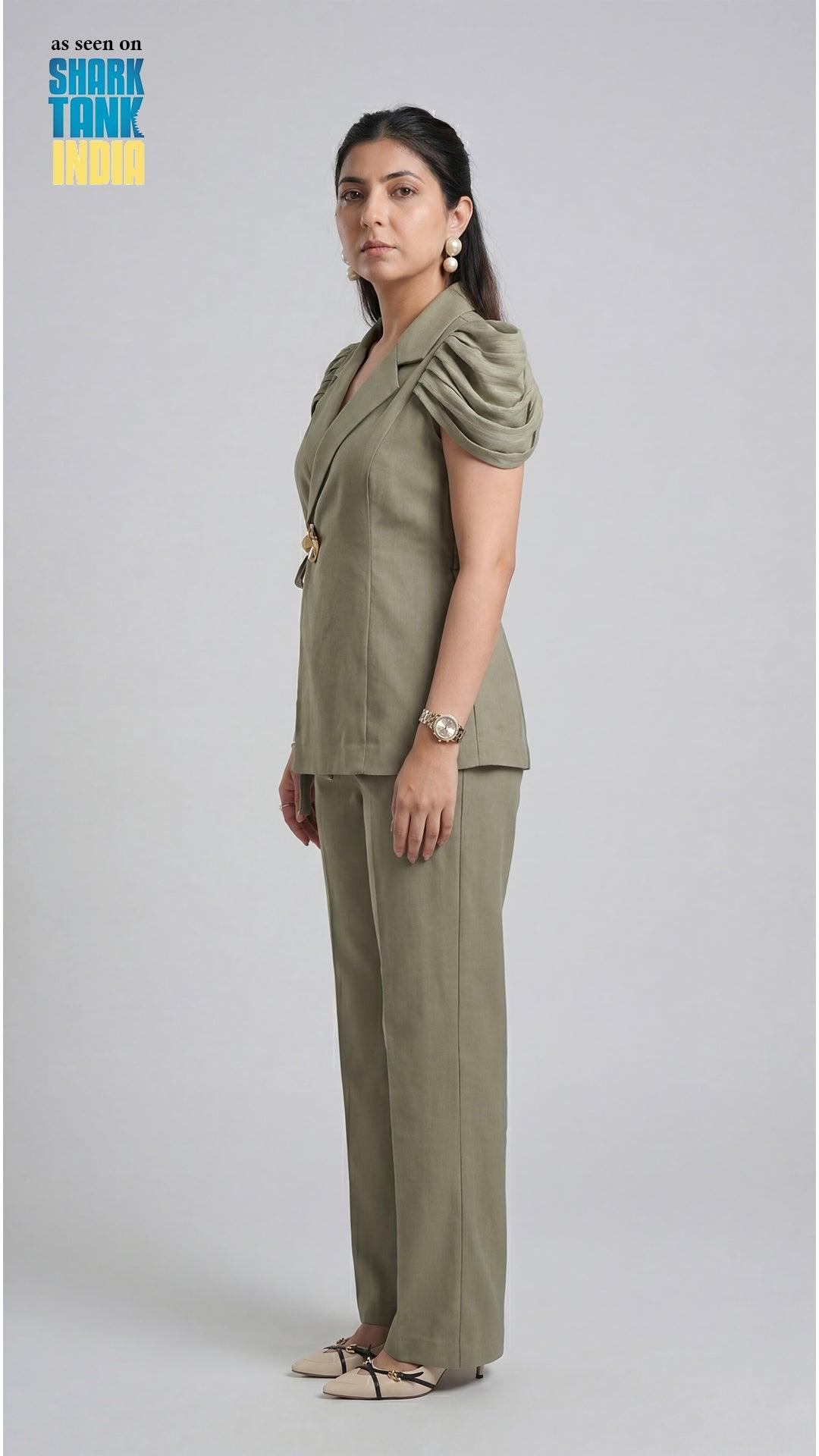 Woman wearing a green outfit on a plain background