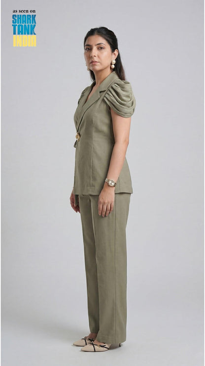 Woman wearing a green outfit on a plain background