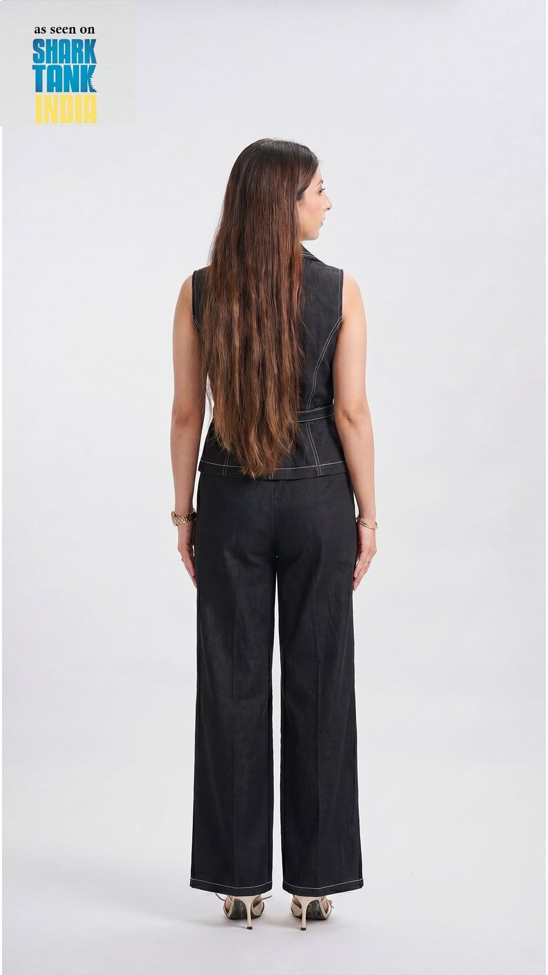 Woman wearing a black denim jumpsuit on a white background with 'Shark Tank' branding.