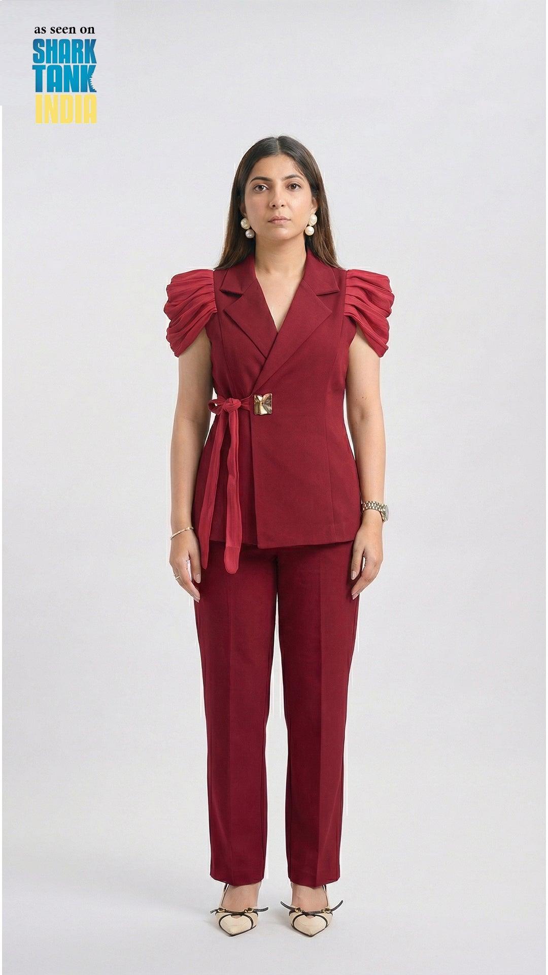 Woman wearing a red outfit with ruffled sleeves on a white background