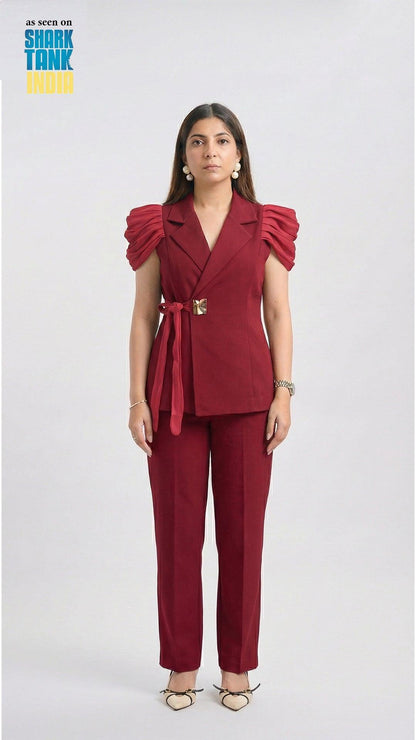 Woman wearing a red outfit with ruffled sleeves on a white background