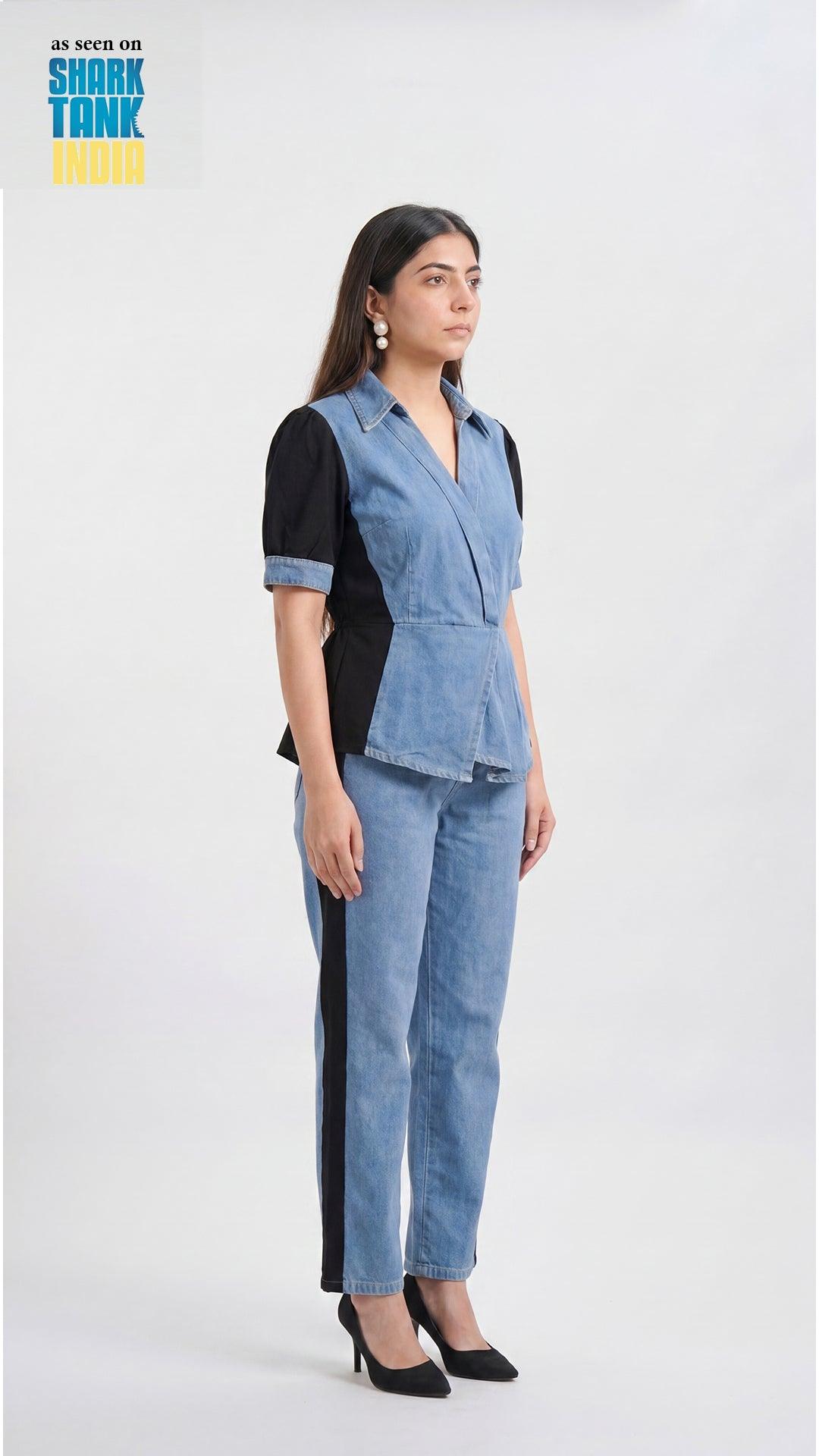 Woman wearing a denim outfit with a black top on a white background