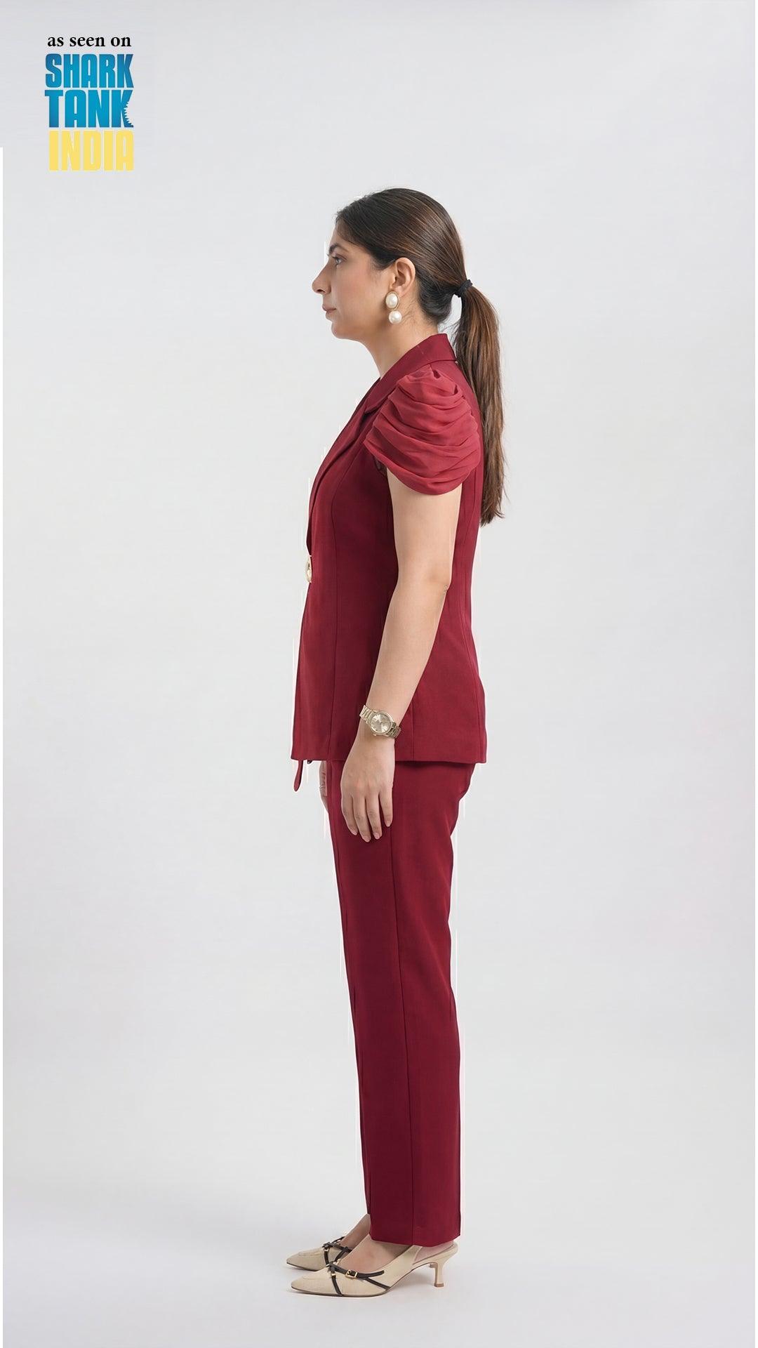 Woman wearing a maroon outfit on a white background with 'Shark Tank India' branding.