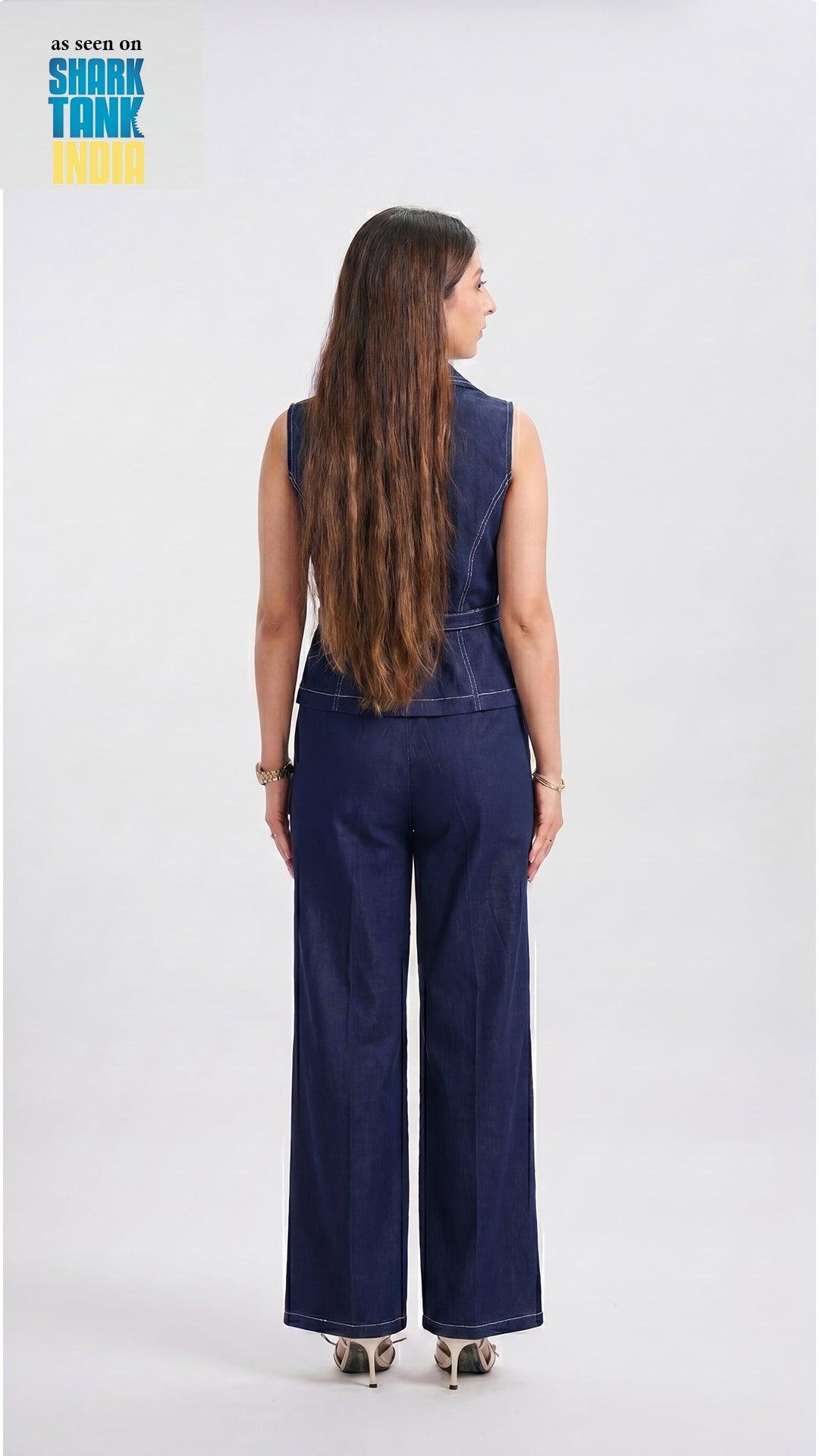 Person wearing a navy blue denim jumpsuit on a white background with 'Shark Tank' branding.