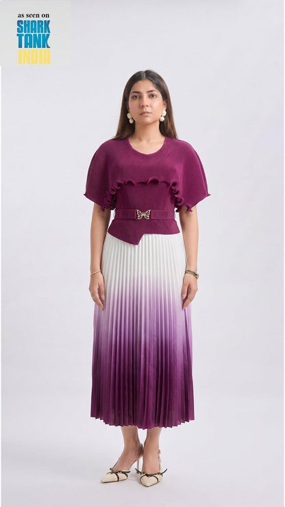 Woman wearing a purple top and gradient skirt on a white background