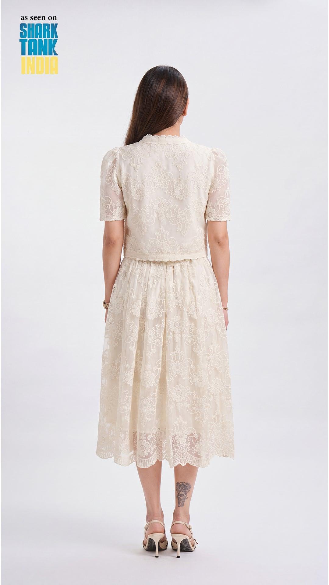 Woman wearing a beige lace dress on a white background with 'Shark Tank' branding.