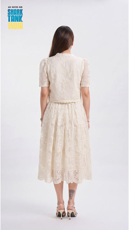 Woman wearing a beige lace dress on a white background with 'Shark Tank' branding.