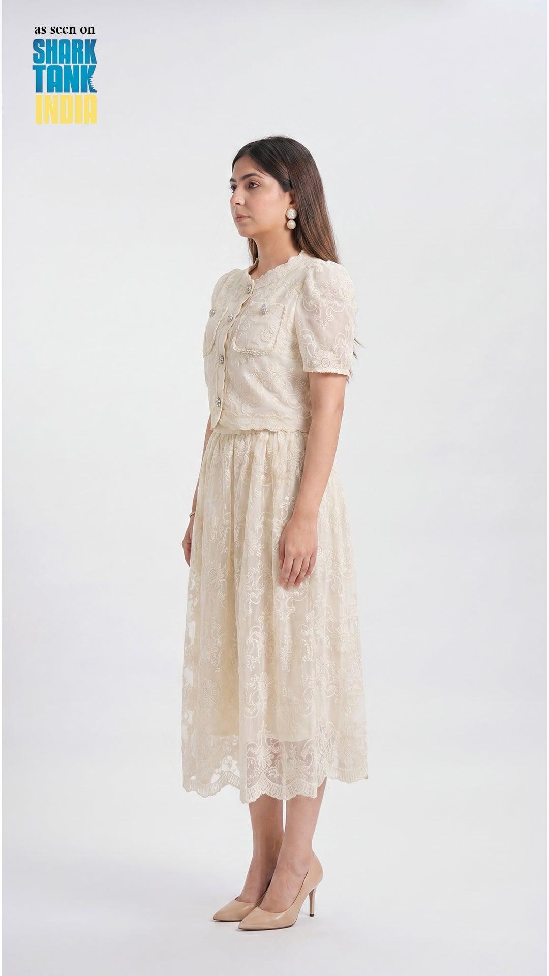Woman wearing a beige lace dress on a white background with 'Shark Tank' branding.